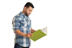 Young happy man holding and posing with the book on white background. photo
