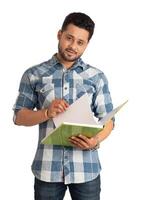 Young happy man holding and posing with the book on white background. photo