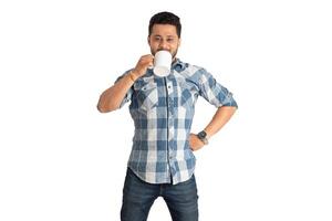 Handsome smiling man with cup of coffee or tea isolated on white background photo
