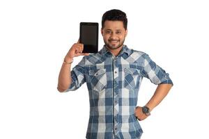 Young handsome man, businessman showing a blank screen of a smartphone or mobile or tablet phone on white background photo