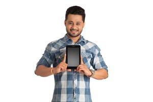 Young handsome man, businessman showing a blank screen of a smartphone or mobile or tablet phone on white background photo