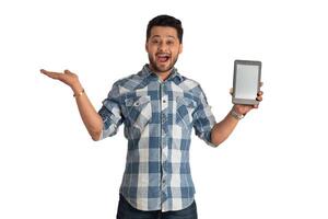 Young handsome man, businessman showing a blank screen of a smartphone or mobile or tablet phone on white background photo