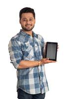 Young handsome man, businessman showing a blank screen of a smartphone or mobile or tablet phone on white background photo