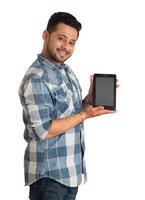 Young handsome man, businessman showing a blank screen of a smartphone or mobile or tablet phone on white background photo