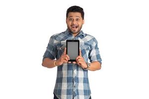 Young handsome man, businessman showing a blank screen of a smartphone or mobile or tablet phone on white background photo