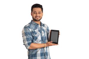 Young handsome man, businessman showing a blank screen of a smartphone or mobile or tablet phone on white background photo