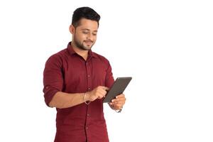 Young handsome man holding and using smartphone or mobile or tablet phone on a white background photo
