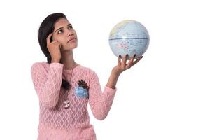 Beautiful Girl holding a world globe isolated on a white background photo