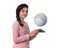 Beautiful Girl holding a world globe isolated on a white background photo