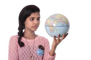 Beautiful Girl holding a world globe isolated on a white background photo