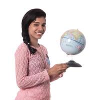 Beautiful Girl holding a world globe isolated on a white background photo