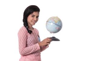 Beautiful Girl holding a world globe isolated on a white background photo