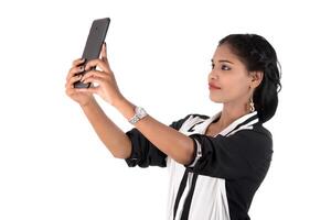business woman using a mobile phone or smartphone isolated on a white background photo