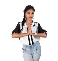 Beautiful Indian girl with welcome expression inviting, greeting Namaste photo