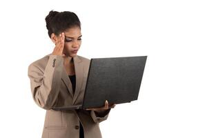 Thoughtful woman with a laptop - isolated over a white background photo