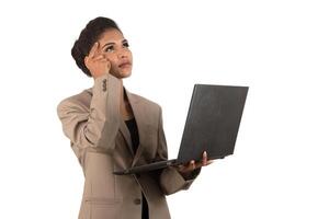 Thoughtful woman with a laptop - isolated over a white background photo