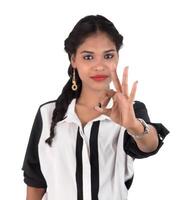 Smiling cheerful girl showing okay sign or thumbs up isolated on white background photo