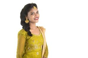 Portrait of beautiful traditional Indian girl posing on white background. photo