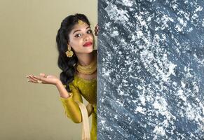 Traditional Girl holding and showing textured board photo