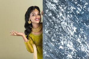 Traditional Girl holding and showing textured board photo