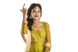 Smiling cheerful girl showing sign isolated on white background photo