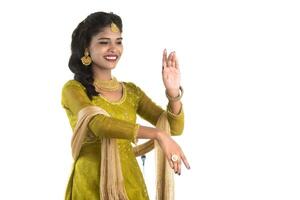 Smiling cheerful girl showing sign isolated on white background photo