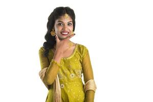 Smiling cheerful girl showing sign isolated on white background photo