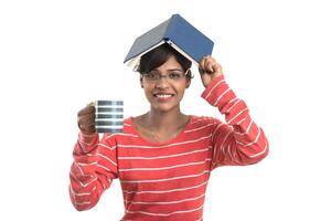 Beautiful young girl with book and cup of coffee posing on a white background. photo