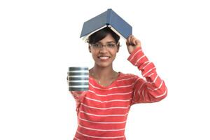 Beautiful young girl with book and cup of coffee posing on a white background. photo