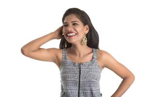 Portrait of beautiful young smiling girl posing on white background photo