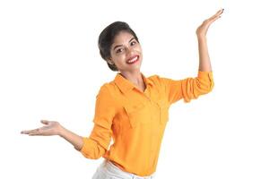 Beautiful girl holding and presenting something in the hand with happy smiling. photo