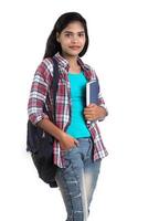 young Indian woman with backpack standing and holding notebooks, posing on a white background. photo
