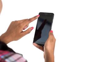 Young Indian girl using a mobile phone or smartphone isolated on a white background photo