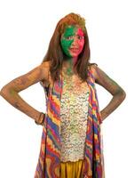 Portrait of a happy young girl with a colorful face on Holi color festival on white background photo