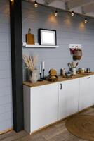 Beautiful stylish white real kitchen in Scandinavian style with wooden top and grey wooden walls photo