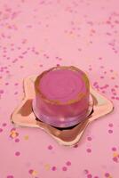 Trendy pink bento cake for Mom's day, birthday, Valentine's Day on a golden plate in the shape of a star on a pink background with confetti photo