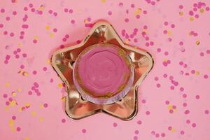 Trendy pink bento cake for Mom's day, birthday, Valentine's Day on a golden plate in the shape of a star on a pink background with confetti photo