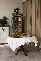 Easter table with a white tablecloth and a vase of flowers on it photo