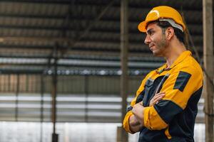 Caucasian engineer using a laptop in a factory. man working in plastics factory. photo