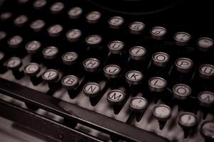A close-up shot of an old typewriter keyboard with the letters H, J, K, L, N, M, and O visible photo