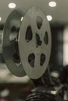 A close-up view of a film reel in a projector, showcasing the intricate details of the mechanism that brings movies to life photo