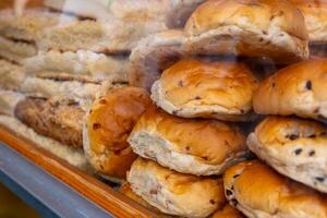 Freshly baked buns are displayed in a bakery window photo