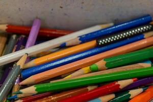 A close-up of a colorful assortment of pencils in a container photo