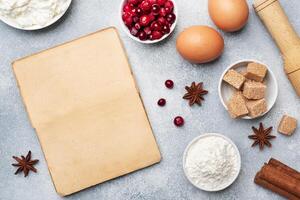 Ingredients for baking cookies, cupcakes and cake. Raw foods eggs flour sugar cottage cheese cranberries on a grey background with copy space. photo