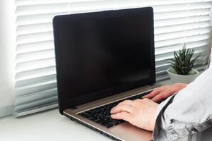 Woman working at computer hands at home. Concept of working and learning at home. Copy space. photo