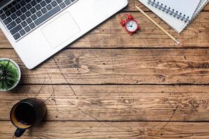 Working wooden table at home or in the office. Computer laptop coffee cactus. Flat lay conceptions Copy space. photo