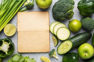 Frame Fresh green vegetables and herbs on a grey concrete background. Copy space. photo