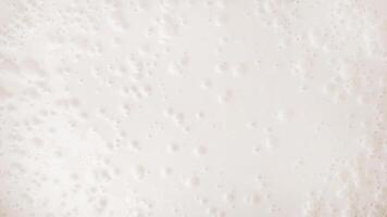Close up of frothy milk foam texture, symbolizing freshness and dairy products, perfect for breakfast or coffee related themes photo