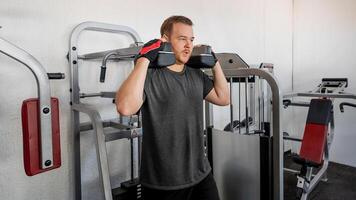 Caucasian man lifting dumbbells at a gym, highlighting fitness goals and determination, ideal for New Years resolution concepts photo