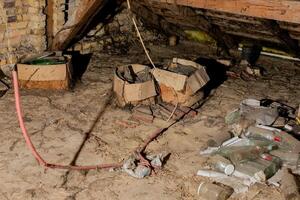 Cluttered dusty attic filled with old boxes and bottles highlighting the need for spring cleaning and decluttering photo